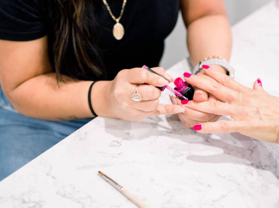 A woman getting nail paint at the spa