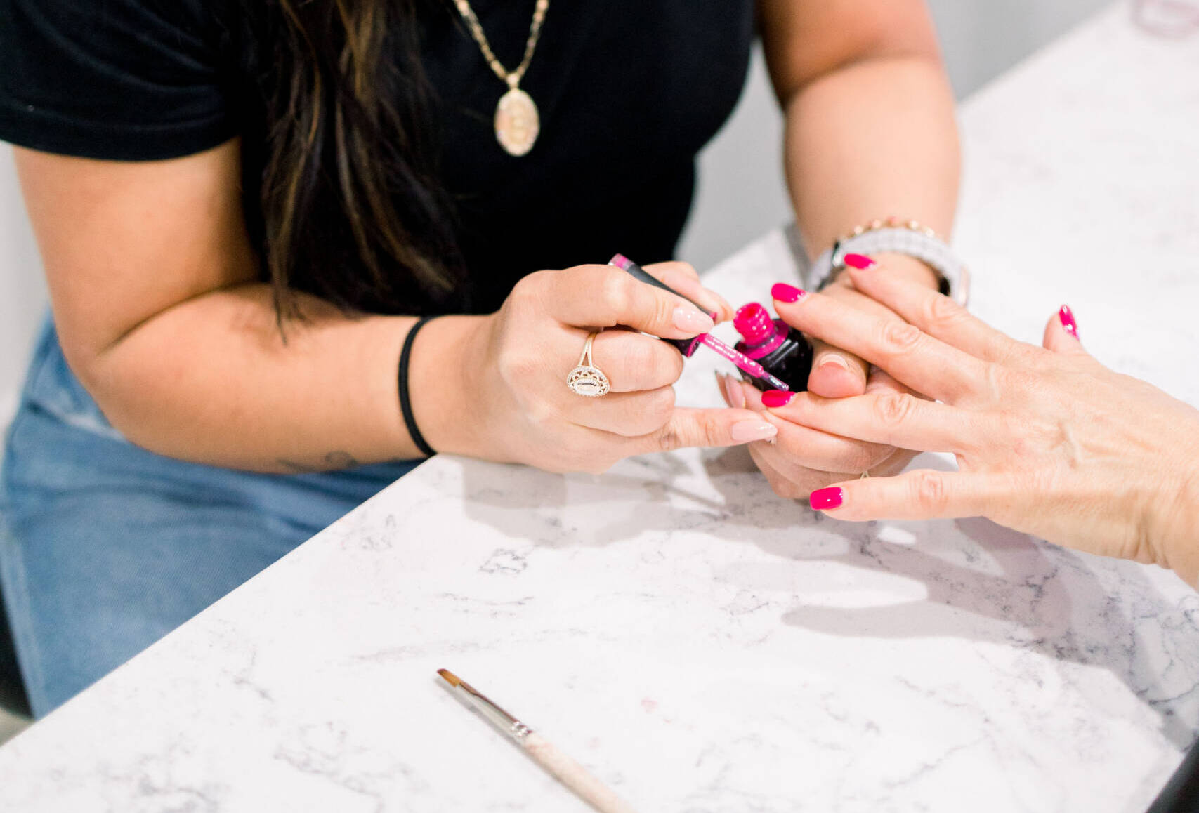 A woman getting nail paint at the spa