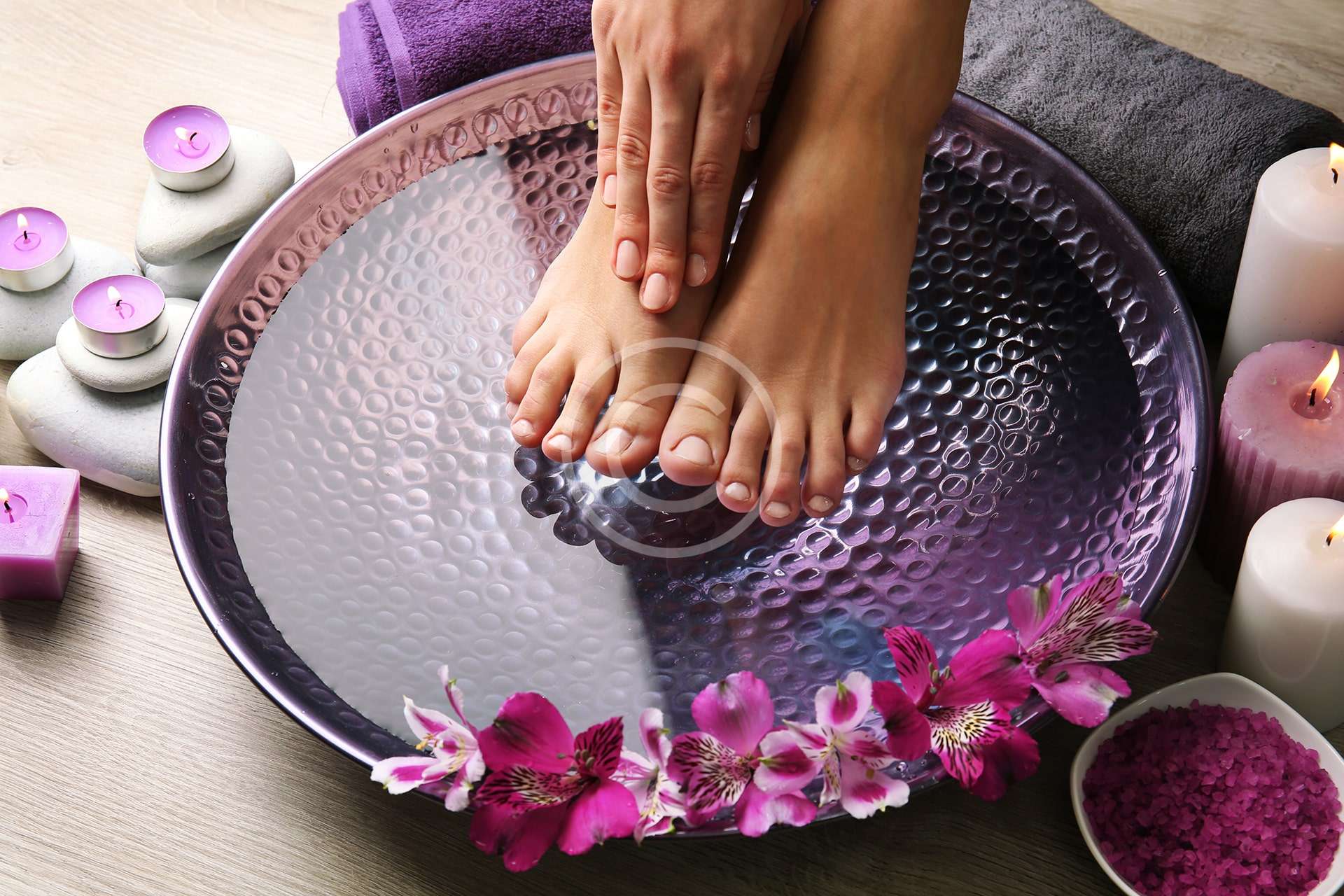 Freshly massaged feet with herbs and flowers around them