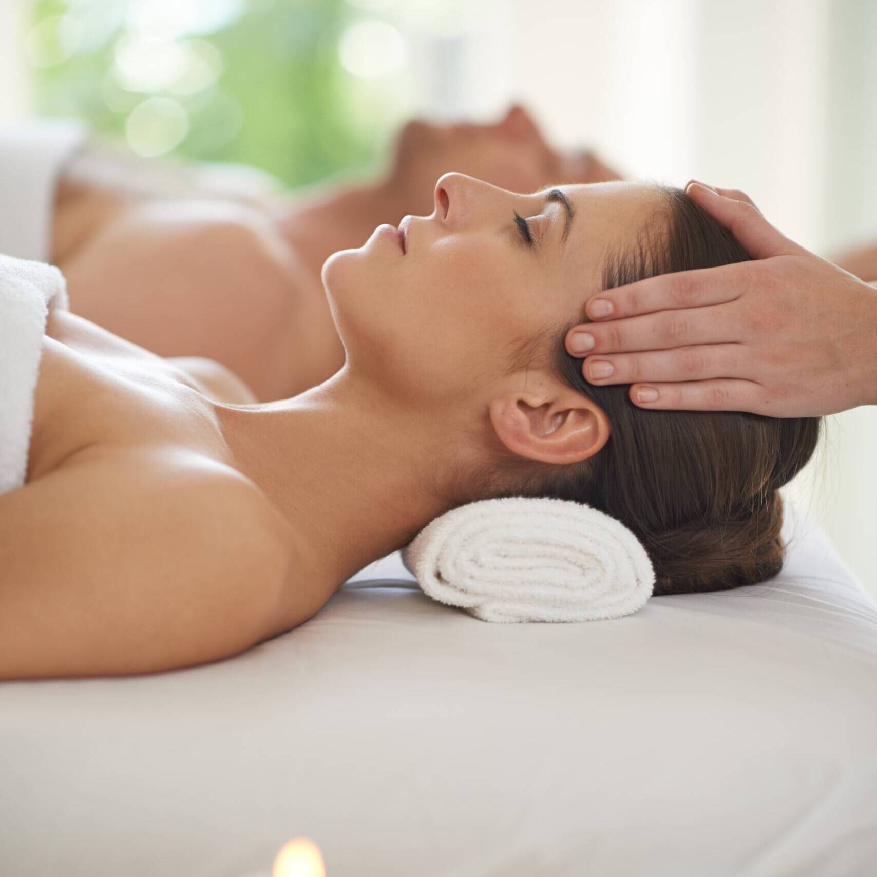 A woman getting body massage at salon