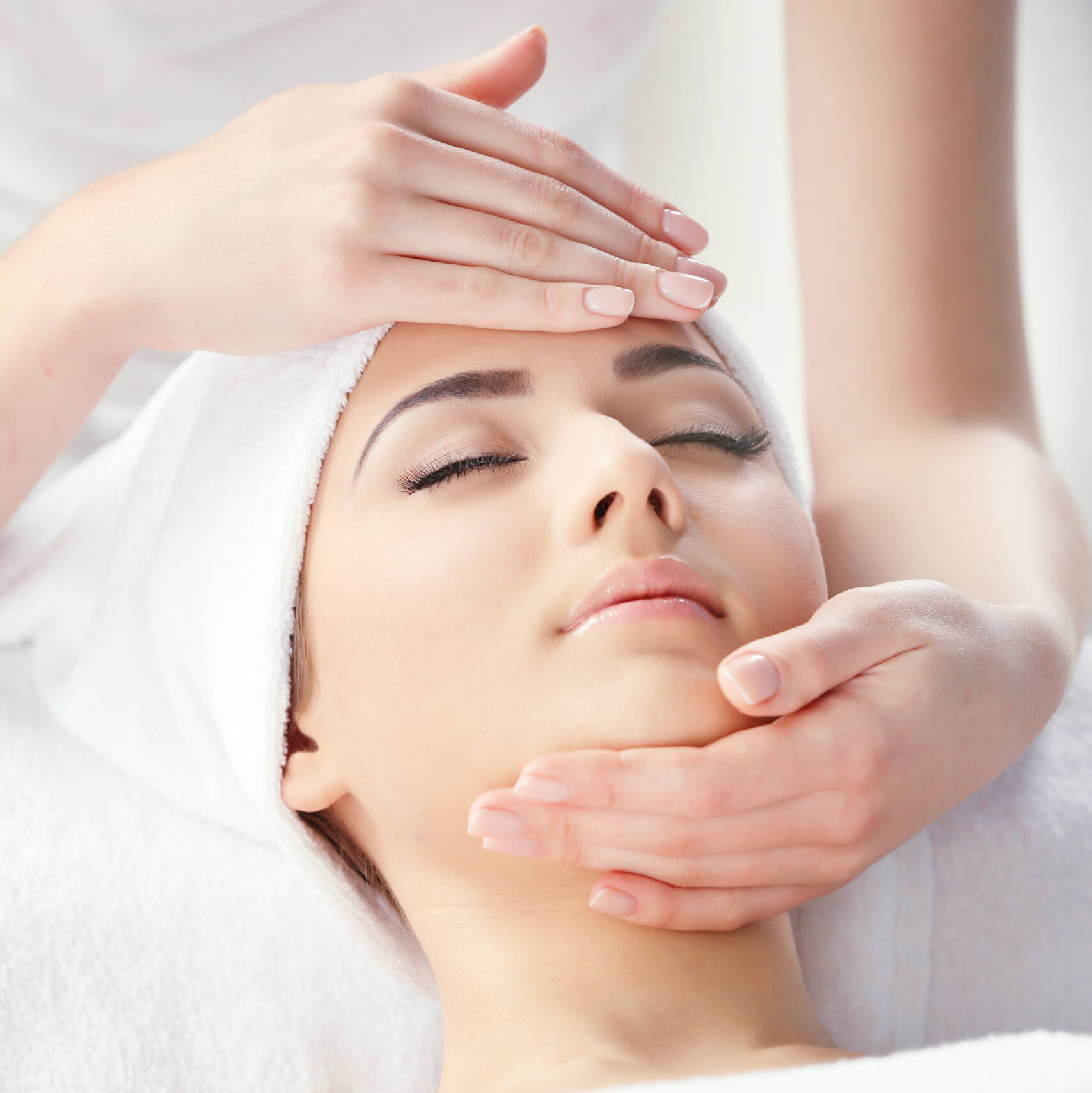 A woman getting face massage at salon